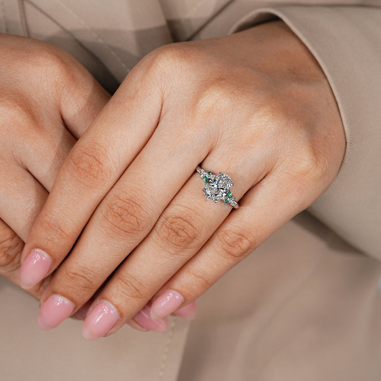 Oval diamond ring with round and marquise side stones.