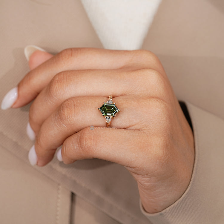 Hexagon shape diamond ring with trillion side stones in a three stone style.