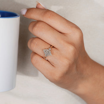 Art Deco trilogy diamond ring with kite side stones.