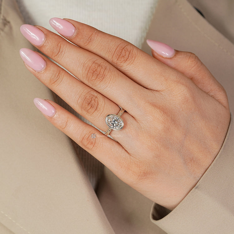 Lab grown oval diamond ring with milgrain details.