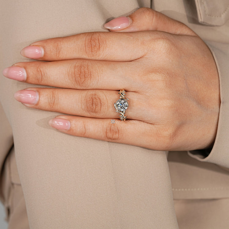 Three prong engagement ring with round center diamond.