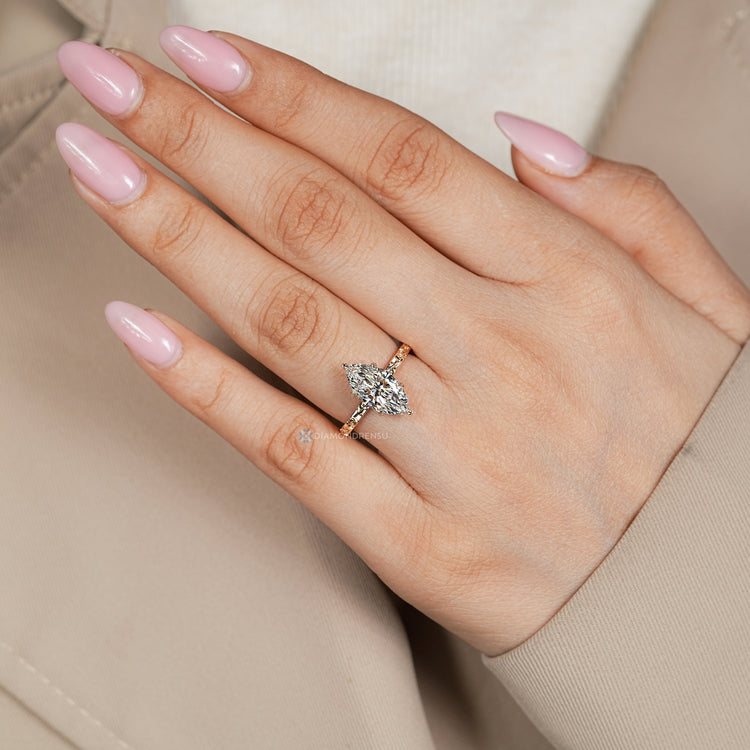 Marquise engagement ring with a six leaf style prong setting.