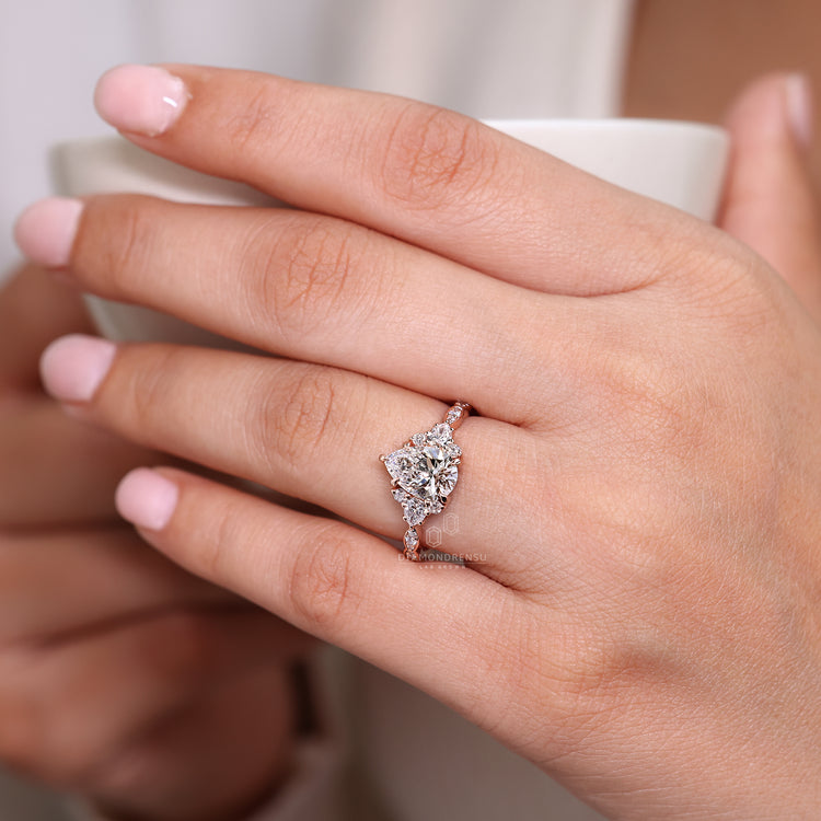 Handmade jewelry pear cut cluster engagement ring design.
