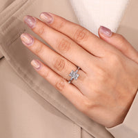 Distance pave ring showcasing radiant cut diamond with marquise cut accents.

