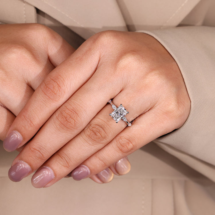 White gold diamond ring with radiant cut diamond and hidden halo.
