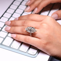 Round diamond hidden halo ring with pave band.

