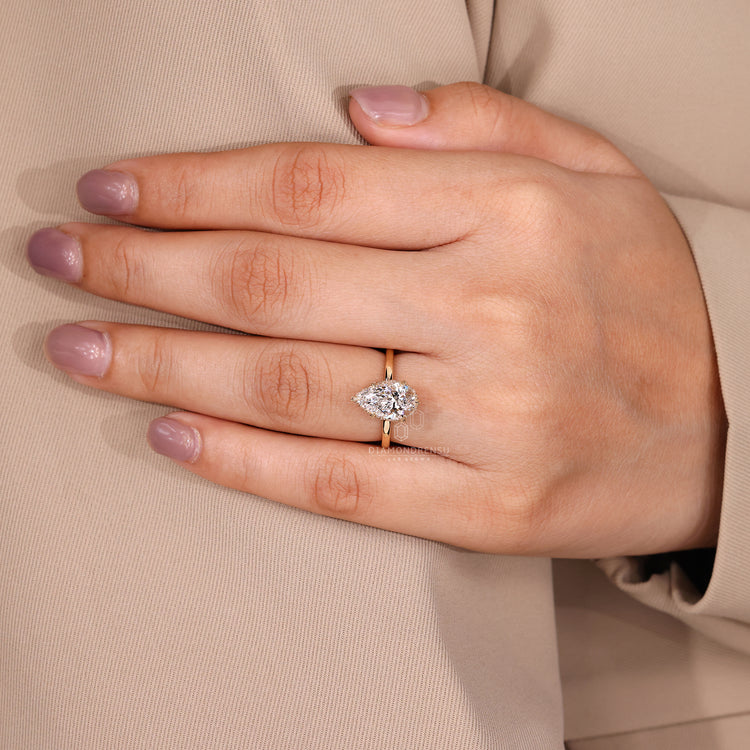 IGI certified hidden halo engagement ring with pear cut centerpiece.
