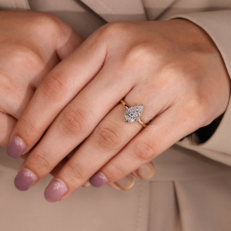 Diamondrensu engagement ring featuring pear cut solitaire and leaf prongs.
