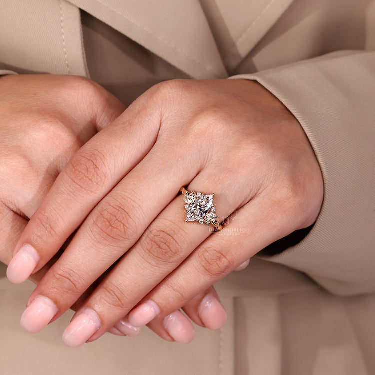 Custom engagement ring with round cut side stones and yellow gold finish.
