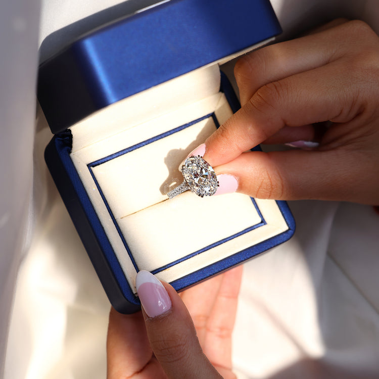 Oval diamond ring with double claw prong setting.
