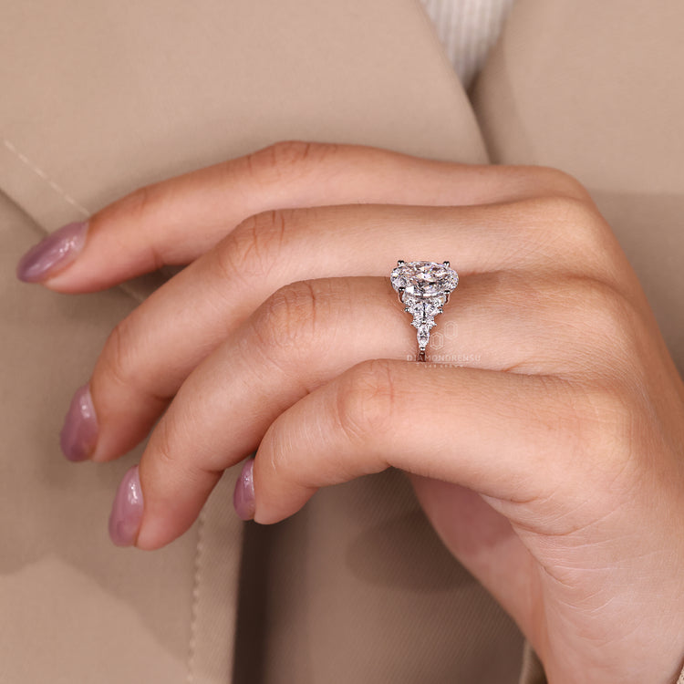 Oval cut diamond ring with custom design and secure prong setting.
