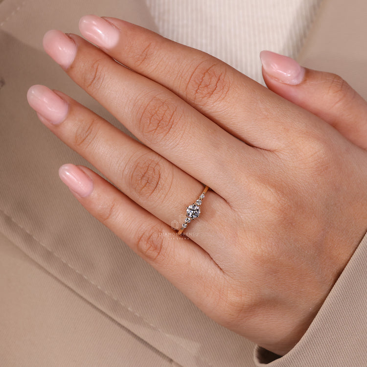 Diamondrensu engagement ring in yellow gold with three stone arrangement.
