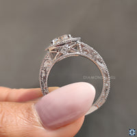 Vintage halo ring with a brilliant moissanite stone in the center for added sparkle.
