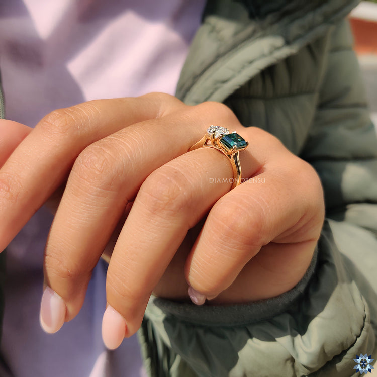 Handmade ring featuring pear and emerald cut moissanite stones
