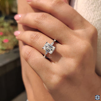 Round diamond ring with an emerald cut moissanite center for a unique look.
