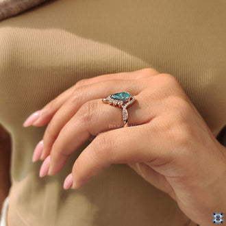 Handmade ring featuring pear cut cyan blue moissanite

