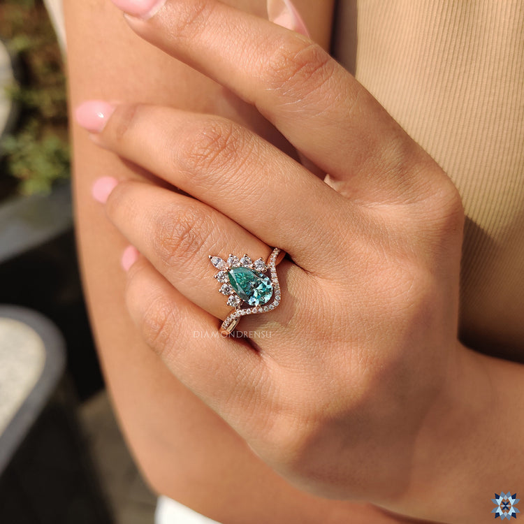 Half halo engagement ring with pear cut cyan blue moissanite
