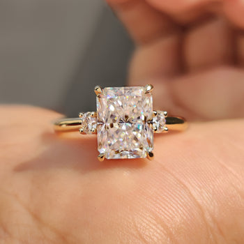 Radiant cut engagement ring in a modern yellow gold finish.
