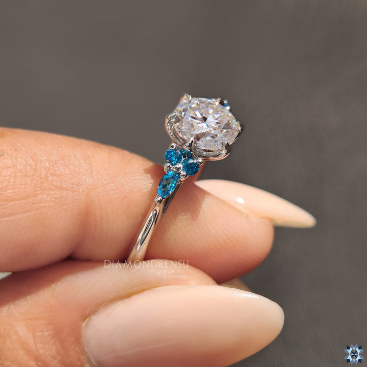 Seven stone ring blue round cut sidestones white gold ring.
