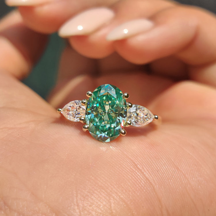 Three stone oval ring pear side stones green moissanite oval.
