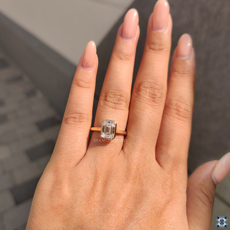 Emerald moissanite ring set in a graceful cathedral setting.
