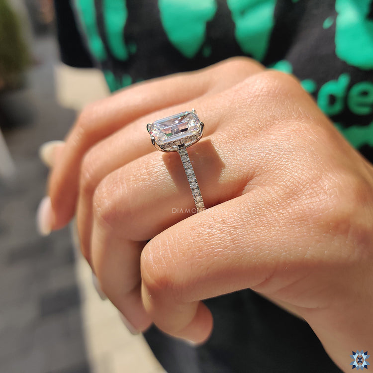 Radiant moissanite ring captured in natural daylight.
