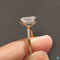 Yellow gold moissanite ring glowing under natural light.

