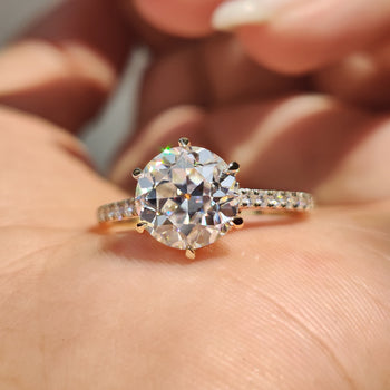 Hidden halo round engagement ring with detailed craftsmanship.
