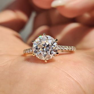 Hidden halo round engagement ring with detailed craftsmanship.
