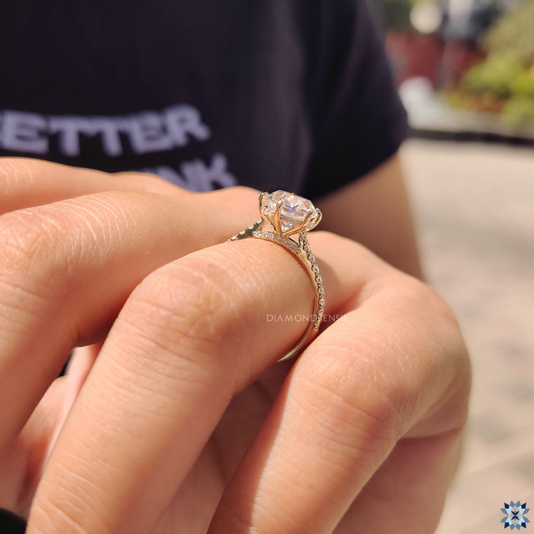 Yellow gold engagement ring with hidden halo style.
