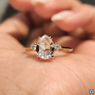 Diamondrensu ring featuring pear moissanite.
