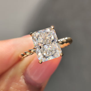 Radiant cut moissanite ring in yellow gold.
