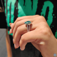 White gold engagement ring with a shimmering halo setting.
