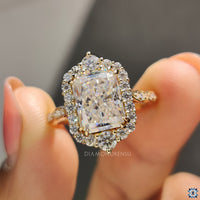 Round cut side stone ring with radiant moissanite for elegance.