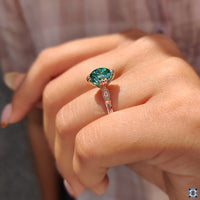 Vintage-inspired engagement ring with dark green gemstone.