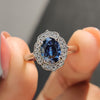 Oval Cut Moissanite Ring set in a vintage halo setting with a cathedral design.
