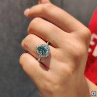 Pave Ring Setting with a stunning cyan blue Moissanite Ring in white gold.
