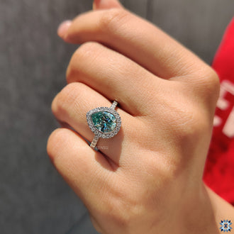 Pave Ring Setting with a stunning cyan blue Moissanite Ring in white gold.
