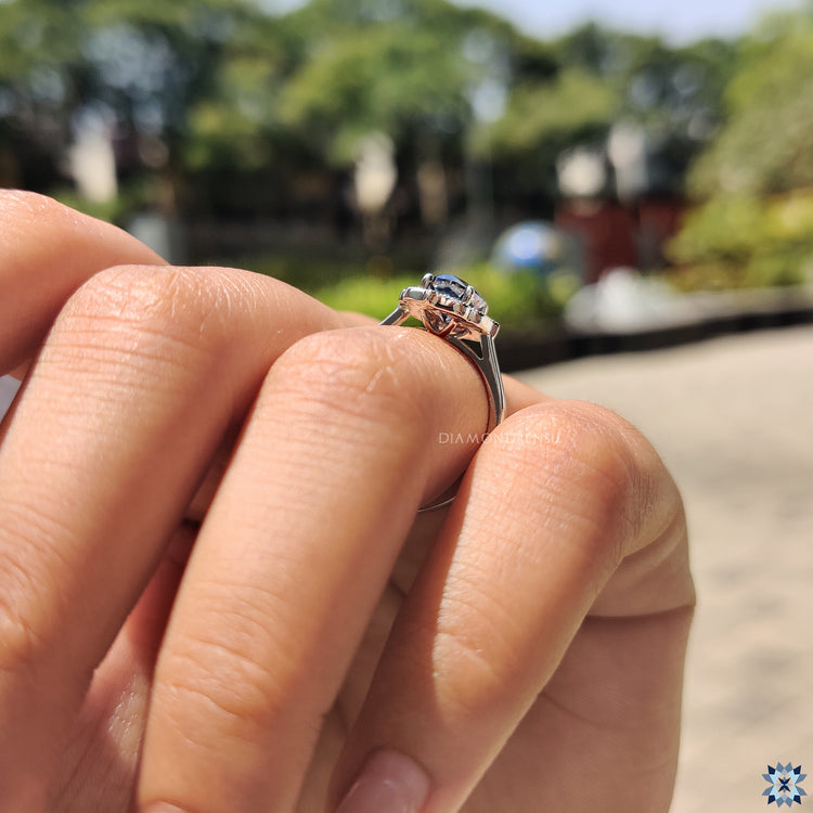 Blue engagement ring with Oval Cut Moissanite and cathedral setting in white gold.
