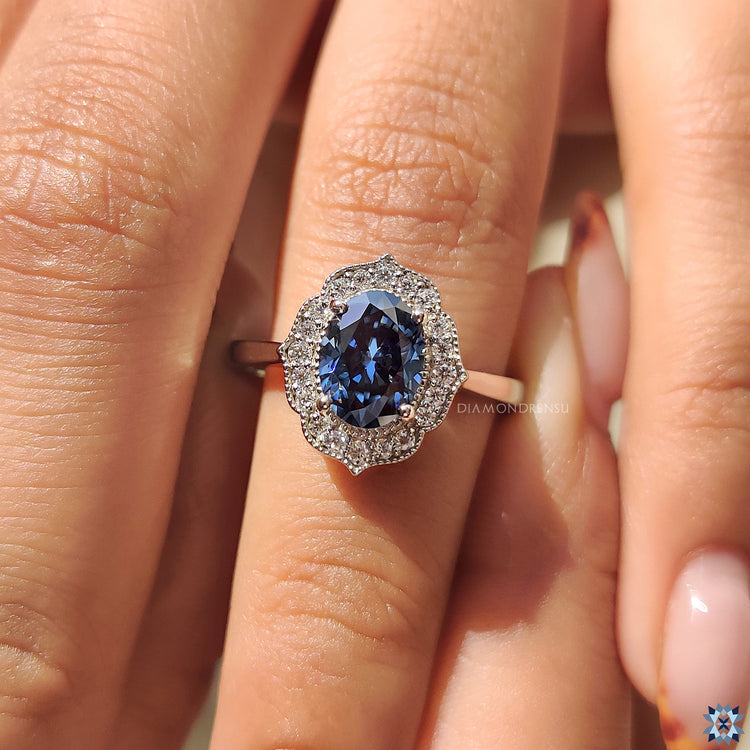 Tapered ring shank with a vintage halo setting for an Oval Cut Moissanite.
