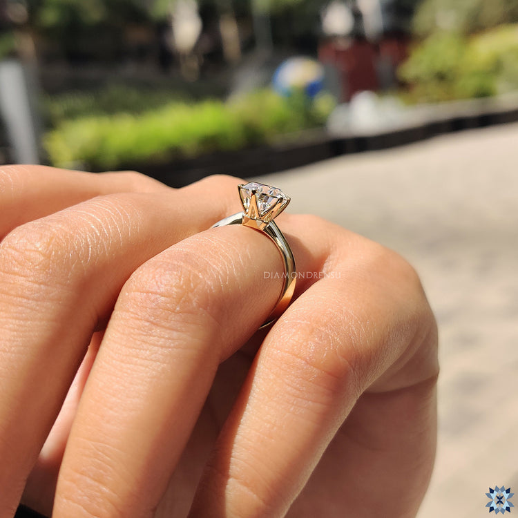 Yellow gold engagement ring with a round cut moissanite, offering a warm and classic style.
