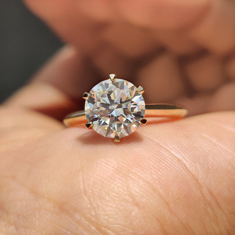 Round cut engagement ring with a brilliant moissanite stone, designed for timeless beauty and elegance.
