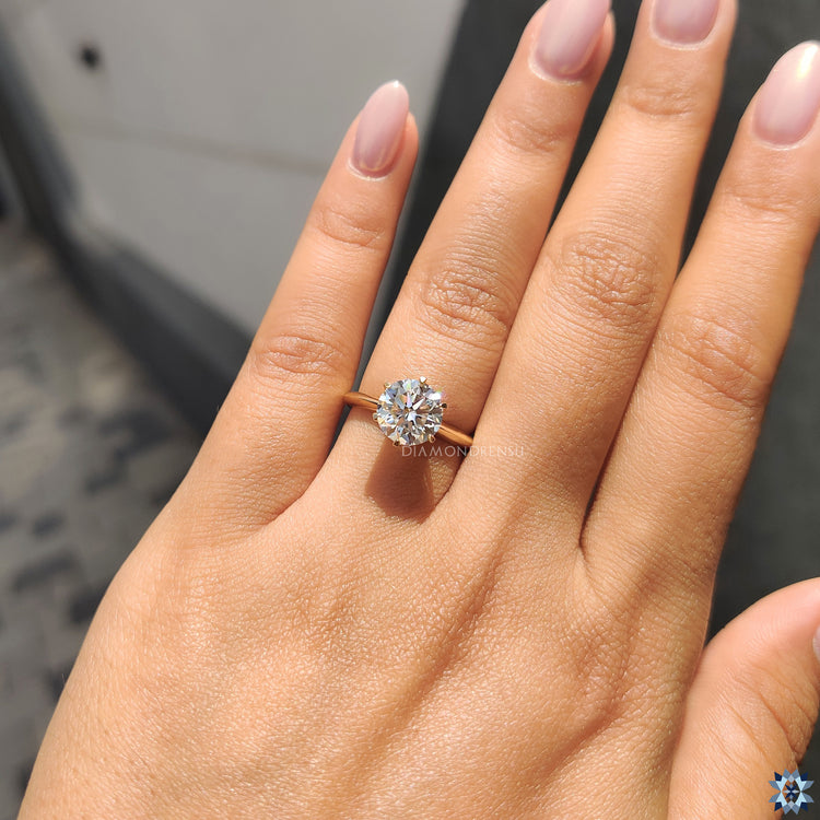 Simple solitaire engagement ring with a round cut moissanite stone, perfect for a minimalist, timeless design.
