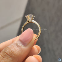 Six prong setting ring featuring a round cut moissanite stone, providing both security and elegance.
