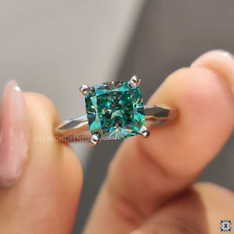White gold engagement ring with a cushion cut moissanite, offering a sleek and sophisticated design.
