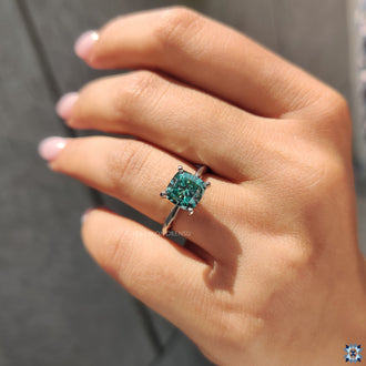 Four tab prong setting ring featuring a cushion cut moissanite, designed to secure the stone with elegance.

