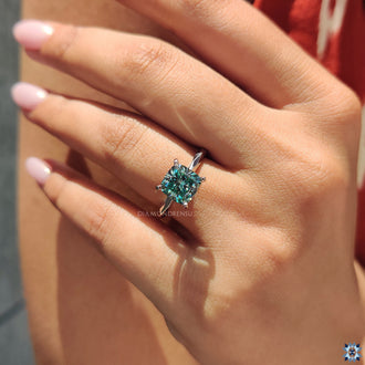 Cyan blue cushion cut moissanite ring, featuring vibrant hues and exceptional clarity for a one of a kind piece.
