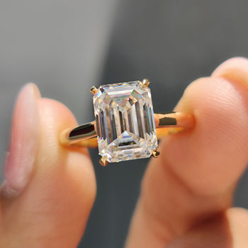 Emerald cut engagement ring, featuring a stunning moissanite stone with a sleek and sophisticated design.
