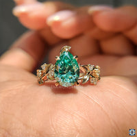 Nature inspired ring with a pear cut moissanite stone, designed to reflect the beauty of the outdoors.
