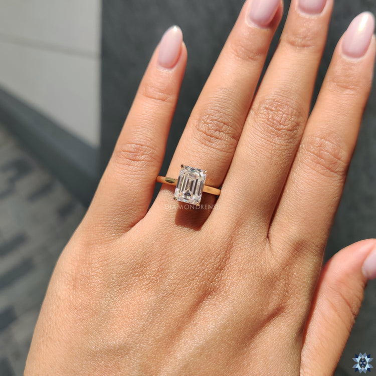 Moissanite engagement ring with an emerald cut stone, offering exceptional clarity and a timeless appeal.
